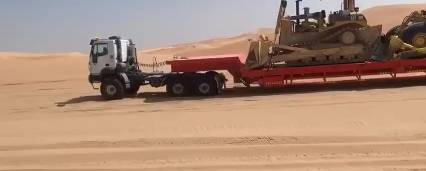 Dozers on a lowbed trailer crossing the desert