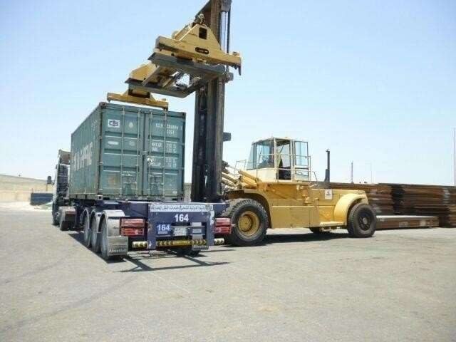 Container handler lifting a container